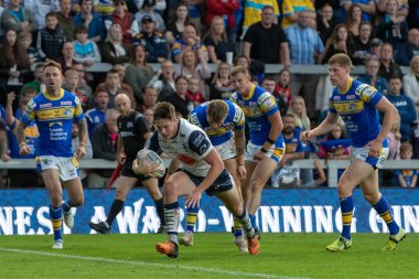 Riley Dean #27 of Warrington Wolves goes over for a try and makes the score 6-4 in the first half 