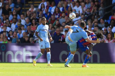 Eberechi Eze of Crystal Palace and John McGinn of Aston Villa tussle for the ball.