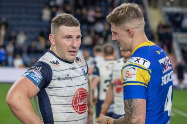 Liam Sutcliffe #4 of Leeds Rhinos and George Williams #7 of Warrington Wolves chatting at full time 