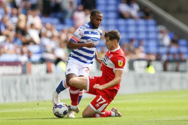 Paddy McNair #17 of Middlesbrough tackles Junior Hoilett #23 of Reading 
