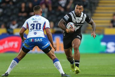 Manu Ma'u #12 of Hull FC runs at Corey Hall #30 of Wakefield Trinity