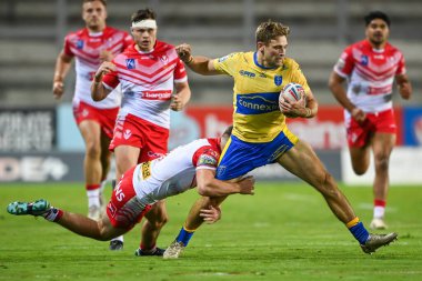 Jimmy Keinhorst #18 of Hull KR is tackled by Jack Welsby #1 of St Helens