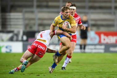 Jimmy Keinhorst #18 of Hull KR is tackled by Jack Welsby #1 of St Helens
