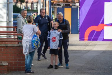 Daryl Powell Head Coach of Warrington Wolves has his picture taken with a young Warrington Wolves supporter ahead of the game 
