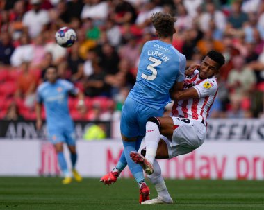 Dennis Cirkin #3 of Sunderland competes for the ball with Jacob Brown #9 of Stoke City 