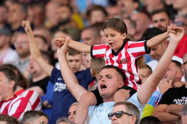 Sunderland fans greet their side on the pitch 