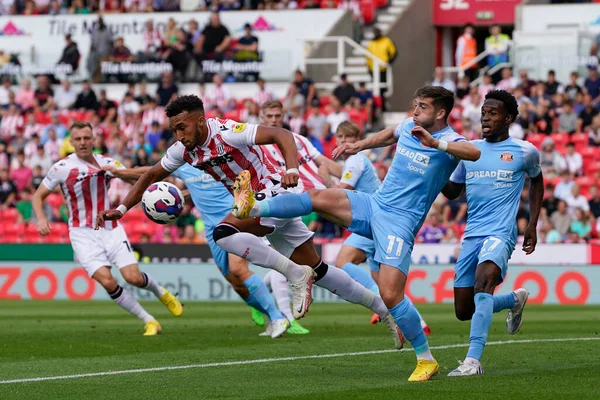 Lynden Gooch #11 of Sunderland competes for the ball with  Jacob Brown #9 of Stoke City 