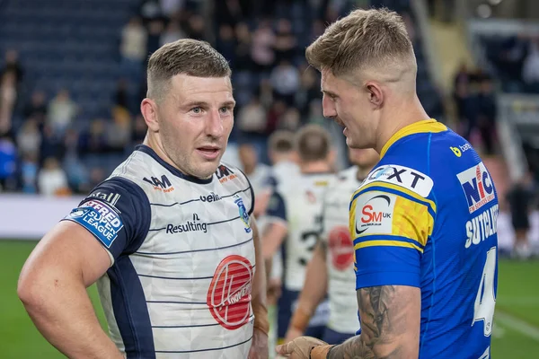 Liam Sutcliffe #4 of Leeds Rhinos and George Williams #7 of Warrington Wolves chatting at full time 