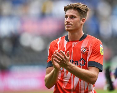 Reece Burke #16 of Luton Town Applauds the travelling supporters