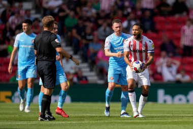 Lewis Baker #8 of Stoke City contests a decision with Referee Oliver Langford