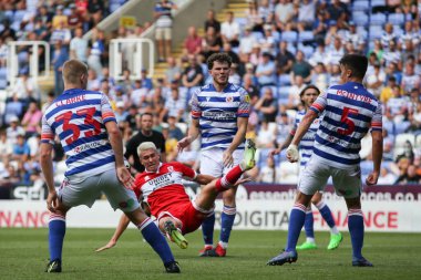 Matthew Hoppe #13 of Middlesbrough goes down under a challenge from Tom Holmes #3 of Reading 