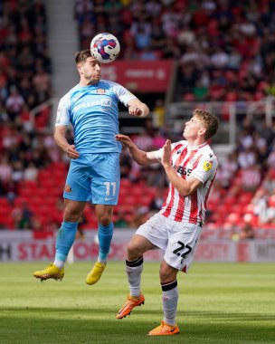 Lynden Gooch #11 of Sunderland wins a header under pressure from Gavin Kilkenny #22 of Stoke City 