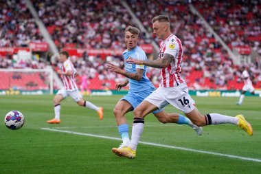 Ben Wilmot #16 of Stoke City chases the ball with Jack Clarke #20 of Sunderland 