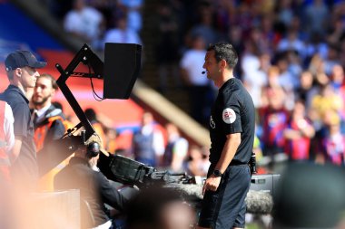 Referee Andy Madley reviews the VAR system before awarding a penalty to Crystal Palace.