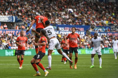 Reece Burke #16 of Luton Town clears his defence Under pressure from Ben Cabango #5 of Swansea City 