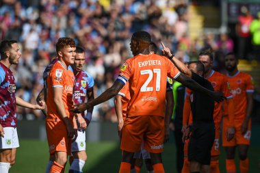 Referee Keith Stroud gives a red card to Sonny Carey #16 of Blackpool