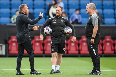 Craig Bellamy Assistant Manager of Burnley chats with David Kerslake and Richard ODonnell Assistant Head Coach of Blackpool during the pre-game warmup 