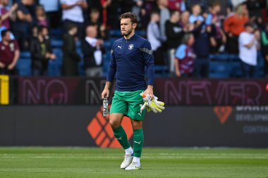 Chris Maxwell #1 of Blackpool makes his way to the dugout before the game
