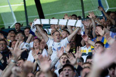 The Leeds United supporters cheer on their team during the game 