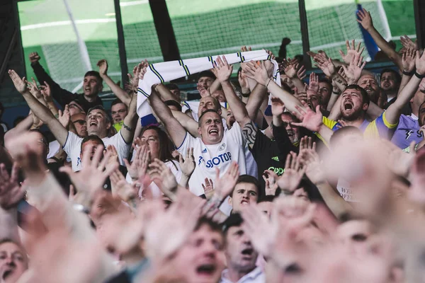 The Leeds United supporters cheer on their team during the game 