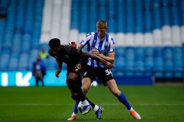 Devante Rodney #10 of Rochdale and Mark McGuinness #34 of Sheffield Wednesday 
