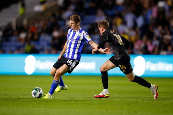 George Byers #14 of Sheffield Wednesday and Ethan Brierley #14 of Rochdale