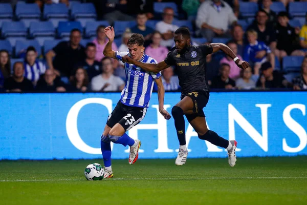 Jay Glover #23 of Sheffield Wednesday and Cameron John #24 of Rochdale