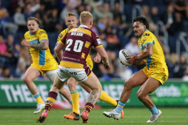 Zane Tetevano #13 of Leeds Rhinos runs at Oliver Wilson #20 of Huddersfield Giants 