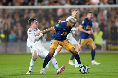 Paul Lewis #22 of Tranmere Rovers grapples with Joelinton #7 of Newcastle United