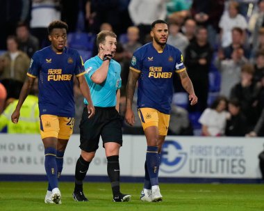 Referee Anthony Backhouse escorts Jamaal Lascelles #6 of Newcastle United off the pitch for more treatment to his nose after he equalised for United