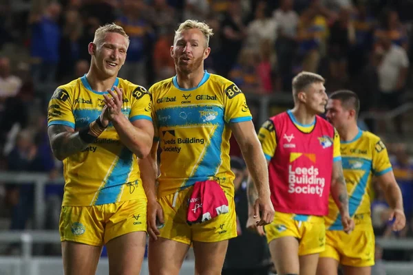 Mikolaj Oledzki #8 of Leeds Rhinos and Matt Prior #10 of Leeds Rhinos acknowledge the Leeds fans