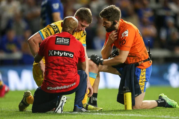 Morgan Gannon #21 of Leeds Rhinos receives medical attention in the second half