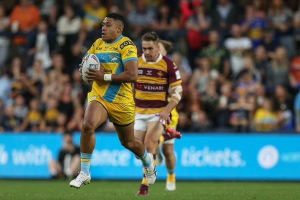 David Fusitua #2 of Leeds Rhinos runs with the ball up the pitch 