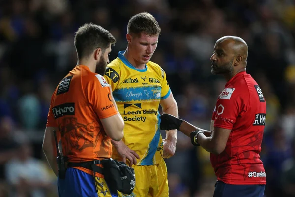 Morgan Gannon #21 of Leeds Rhinos receives medical attention in the second half