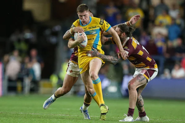 Morgan Gannon #21 of Leeds Rhinos attempts to get through the Huddersfield defence