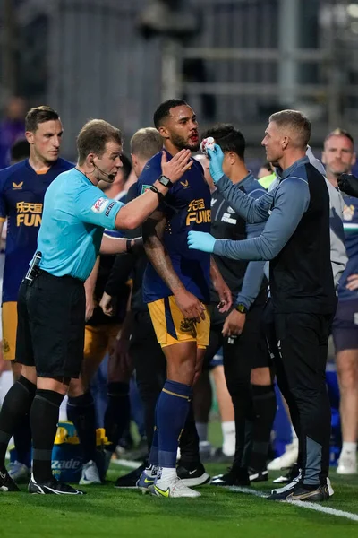 Referee Anthony Backhouse ensures Jamaal Lascelles #6 of Newcastle United gets treatment for a bloody nose 