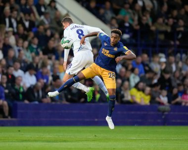 Reece McAlear #8 of Tranmere Rovers competes for a header with Joe Willock #28 of Newcastle United 