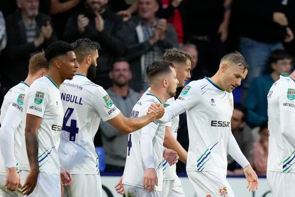 Jordan Turnbull #14 of Tranmere Rovers celebrates with goalscorer Elliott Nevitt
