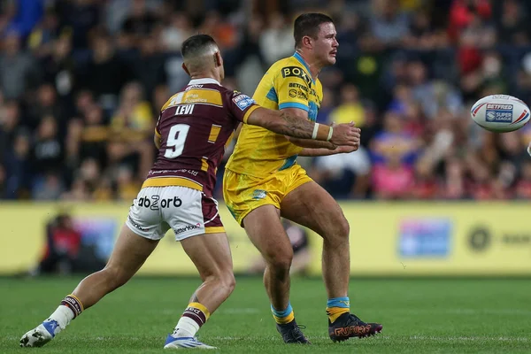 James Bentley #11 of Leeds Rhinos gets his pass away before being tackled