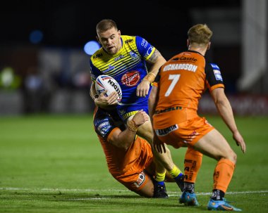 Matt Dufty #36 of Warrington Wolvesis tackled by Paul McShane #9 of Castleford Tigers