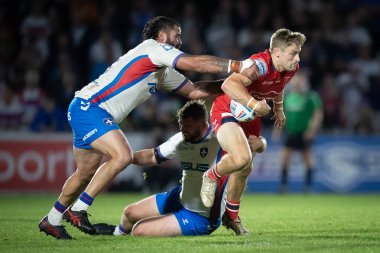 Jimmy Keinhorst #18 of Hull KR is tackled by David Fifita #35 of Wakefield Trinity in the second half 
