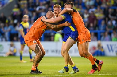 Joe Bullock #15 of Warrington Wolves is tackled by Nathan Massey #14 of Castleford Tigers