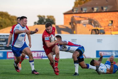 Matt Parcell #9 of Hull KR is tackled by Corey Hall #30 of Wakefield Trinity 