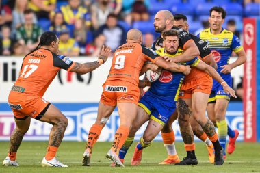 Greg Minikin #21 of Warrington Wolves is tackled by Paul McShane #9 of Castleford Tigers