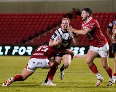 Jordan Johnstone #21 of Hull FC takes fingers in the face from Alex Gerrard #29 of Salford Red Devils