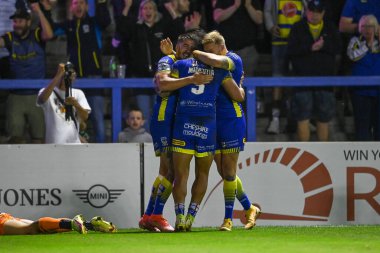 Peter Matautia #3 of Warrington Wolves celebrates his try 