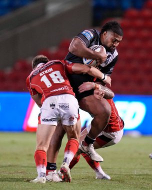 Chris Atkin #18 of Salford Red Devils tackles Chris Satae #10 of Hull FC 
