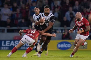 Chris Satae #10 of Hull FC is tackled by Andy Ackers #9 of Salford Red Devils 