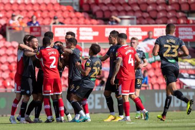 The two teams come together during the second half after a strong challenge by Ben Cabango #5 of Swansea City 