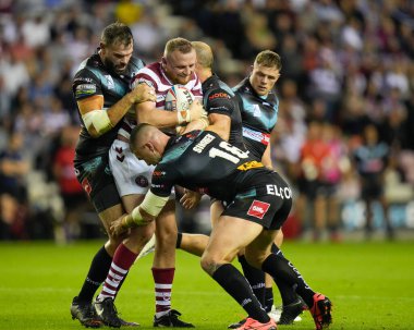 Curtis Sironen #16 and Alex Walmsley of St Helens tackle Brad Singleton #8 of Wigan Warriors